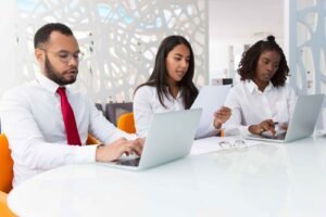 People who are computer literate in Kenya working in an office.