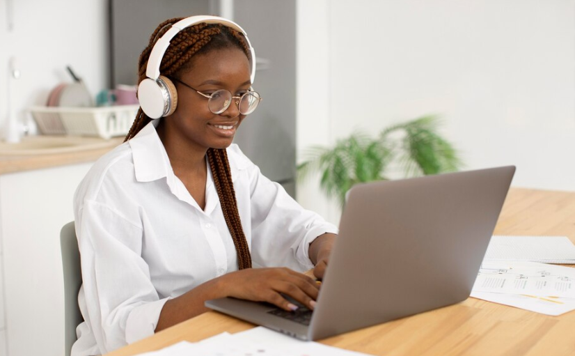 A woman doing online jobs in Kenya. She is also using the best laptop for graphics design.