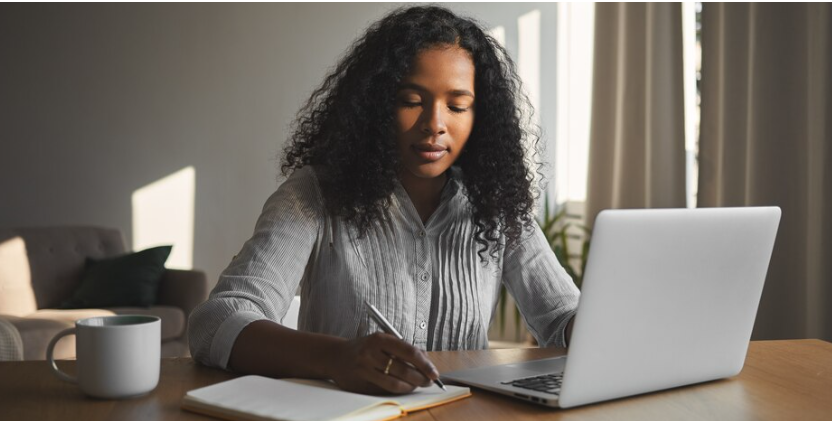 A lady doing online writing in Kenya.